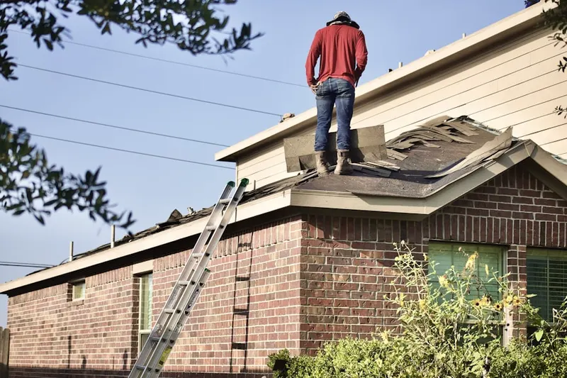 Professional roofer working on a residential roof in Urbana